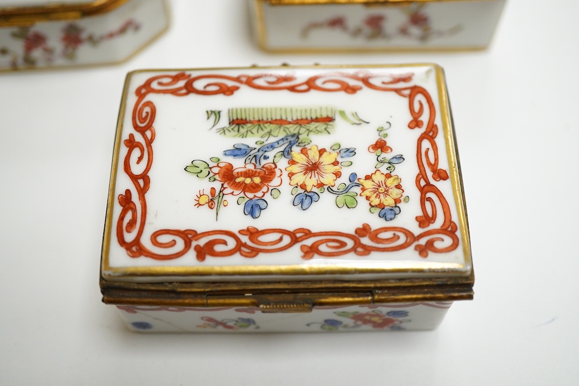 Three early 20th century French porcelain snuff boxes with floral decoration, 7cm wide